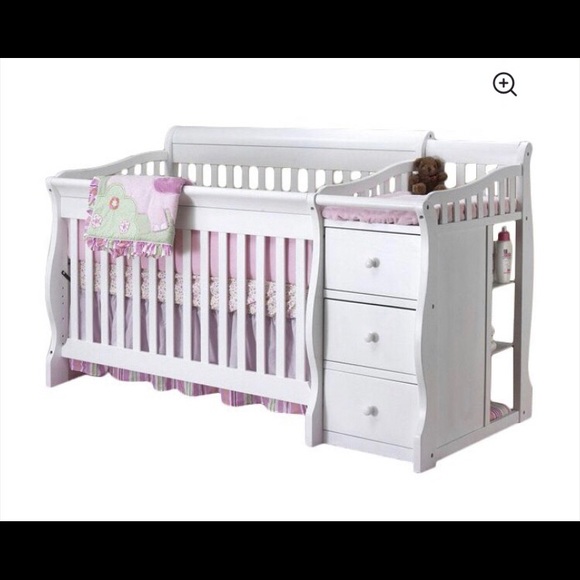 white crib with attached changing table